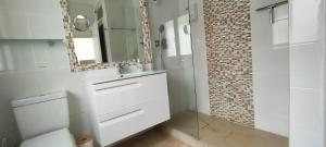 a bathroom with a sink and a mirror at Beach House El Saladillo in Estepona +16 photos