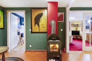a living room with a wood stove in a room at Art-Wohnung in Beierstedt