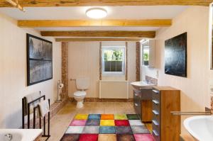 a bathroom with a toilet and a sink at Art-Wohnung in Beierstedt +33 photos