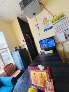 a room with a table with a calendar on the wall at MSN-Gate1Temple in Srikalahasti +1 photo