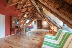 a large room with wooden floors and wooden ceilings at La Ketzerie à Adervielle in Adervielle