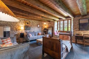 a living room with a stone wall at La Ketzerie à Adervielle in Adervielle