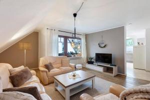 a living room with two couches and a tv at Ferienwohnung Grobbel in Schmallenberg