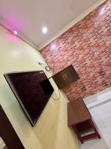 a room with a brick wall and a pair of scissors at MSN-Gate1Temple in Srikalahasti