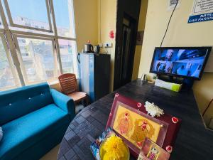 a living room with a blue couch and a table at MSN-Gate1Temple in Srikalahasti