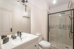 a bathroom with a sink and a toilet and a shower at Apartamento Marte Centro in Los Cristianos +13 photos