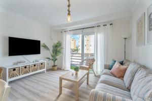 a living room with a couch and a tv at Apartamento Marte Centro in Los Cristianos