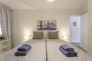 a bedroom with a bed with two towels on it at Apartamento Marte Centro in Los Cristianos
