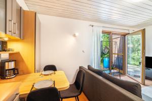 a living room with a table and chairs at Haus Ersfeld – Gartenstudio in Bad Teinach-Zavelstein +17 photos