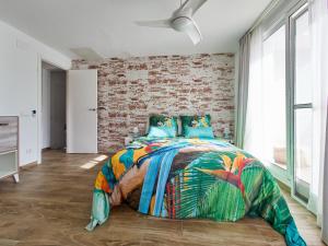 a bedroom with a bed and a brick wall at Naizan in L'Ametlla de Mar +27 photos