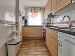 a kitchen with wooden cabinets and a sink at Naizan in L'Ametlla de Mar