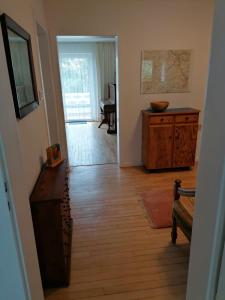 a hallway with a room with a table and a wooden floor at Villa Bulla-ÿ in Bullay