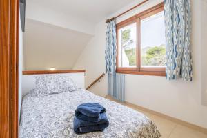 a bedroom with a bed and a window at Can Botana 10 in Cala de Sant Vicenc +23 photos