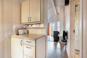 a kitchen with white cabinets and a counter top at Skipper-Lodge Süd in Kosel