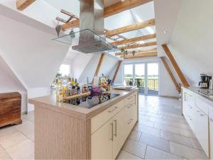 a kitchen with a large island with alcohol bottles on it at Ferienhaus Kuhweid in Drochtersen