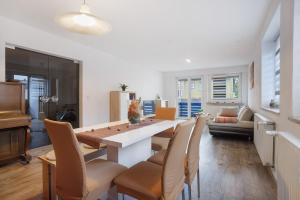a kitchen and dining room with a table and chairs at Allgäu Space in Marktoberdorf