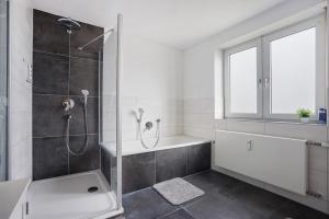 a white bathroom with a shower and a sink at Allgäu Space in Marktoberdorf +22 photos