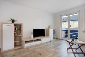 a living room with a flat screen tv on a entertainment center at Allgäu Space in Marktoberdorf