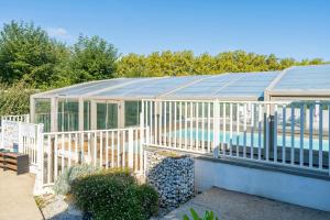a large greenhouse with a swimming pool in it at Petite maison Ortalon - Hasparren in Hasparren