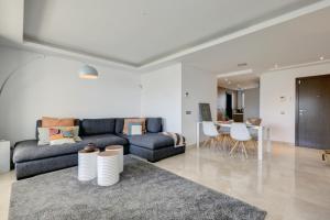 a living room with a couch and a table at Modern frontline beach - Estepona in Estepona