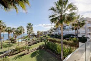 a view of the ocean from the balcony of a resort at Modern frontline beach - Estepona in Estepona