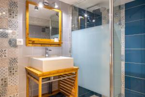 a bathroom with a sink and a mirror at Les Glycines 1 in Les Épesses