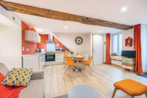 a kitchen and living room with a table and chairs at Les Glycines 1 in Les Épesses