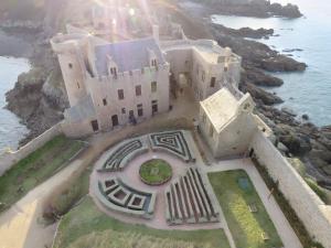 an aerial view of a castle by the water at Les Hirondelles du Cap in Plévenon