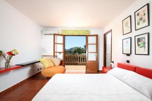 a bedroom with a bed and a chair at Can Seguinot in Pollença +25 photos