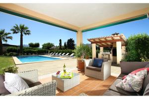 a patio with chairs and a swimming pool at Can Seguinot in Pollença