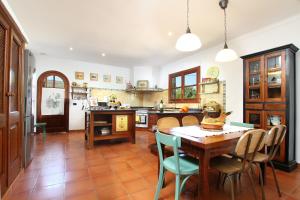 a kitchen with a wooden table and chairs at Can Seguinot in Pollença