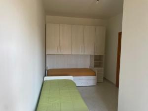 a small bedroom with a bed and cabinets at Massimo Holiday house in Acquarica del Capo