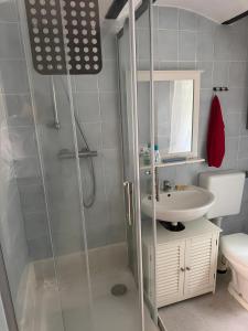 a bathroom with a shower and a sink at Monteurswohnung Rothentor4 in Dorf Mecklenburg +6 photos