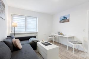 a living room with a couch and a table at Fewo am Mühlenbach in Wehr