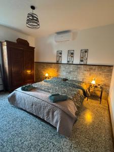 a bedroom with a large bed and a brick wall at Il Vecchio Torchio in Perledo