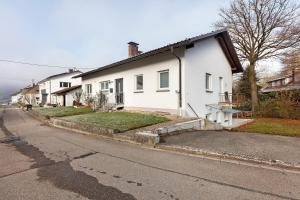 a white house on the side of a street at Fewo am Mühlenbach in Wehr