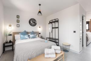 a bedroom with a large bed with blue pillows at La Mihilla in Málaga +13 photos