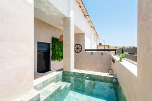 a swimming pool in the middle of a house at La Mihilla in Málaga