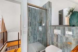 a bathroom with a shower with a glass door at Historische Werkstatt in Gernsbach +14 photos