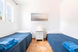 two beds sitting next to each other in a room at Las Estrellas Cala Llombards in Cala Llombards +25 photos