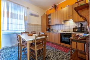a kitchen with a table and chairs in a room at Appartamento Maria- Castelsardo in Castelsardo