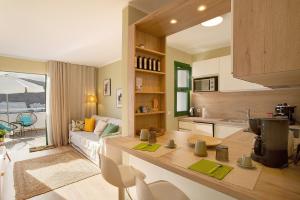 a kitchen and living room with a couch and a table at Zen House in Puerto Rico de Gran Canaria