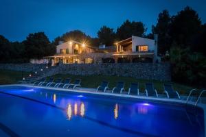 a house with a swimming pool at night at Es Puig de Ses Coves in Santa Eugenia