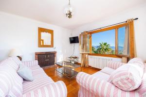 a living room with two white couches and a window at Es Puig de Ses Coves in Santa Eugenia