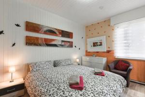 a bedroom with a bed and a chair in it at Casa Heli 1 lake view in San Zeno di Montagna +19 photos