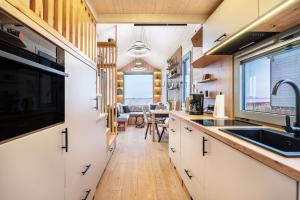 a kitchen with a sink and a counter top at Tiny House Ingo John 'Speedy' in Sandstedt +21 photos