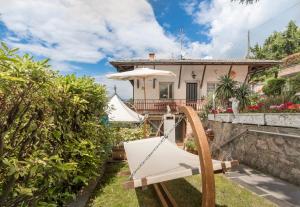 a house with a hammock in the yard at Casa Heli 1 lake view in San Zeno di Montagna