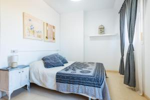 a small bedroom with a bed and a night stand at Duplex Torre La Sal Magic World in Cabanes