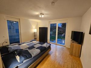 a bedroom with a bed and a flat screen tv at Ferienwohnung Steni in Wehr