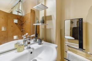 a bathroom with a white sink and a mirror at La Belle Gabarre in Groléjac +47 photos
